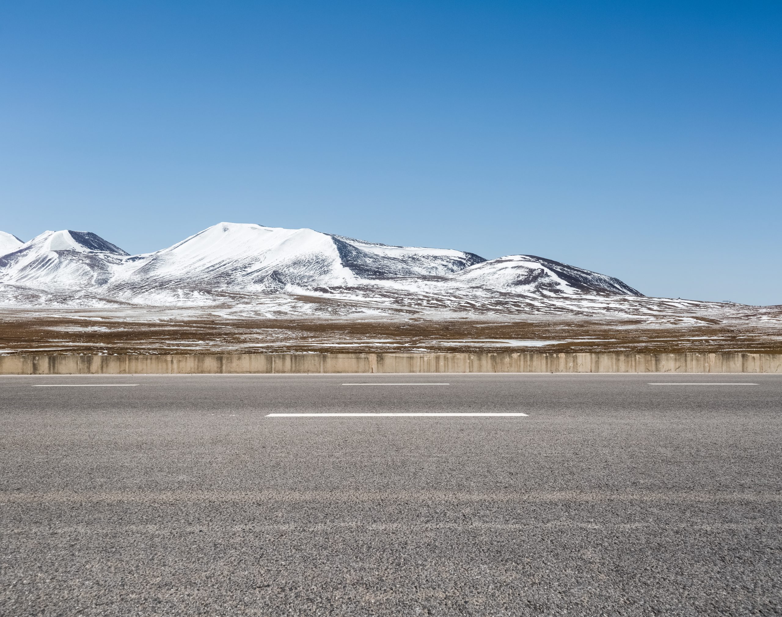 empty asphalt road on snow area plateau